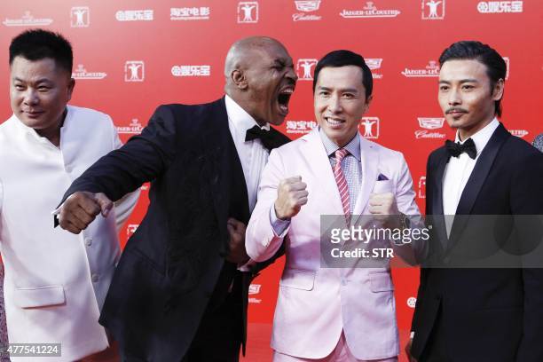 This photo taken on June 13, 2015 shows retired professional boxer Mike Tyson of the US joking around with Hong Kong-US actor Donnie Yen as they...