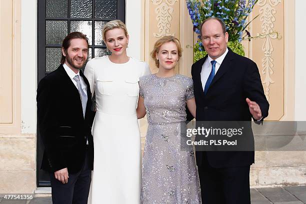 Prince Albert II of Monaco and Princess Charlene of Monaco pose with actors Aaron Stanford and Amanda Schull during the Monaco Palace cocktail party...