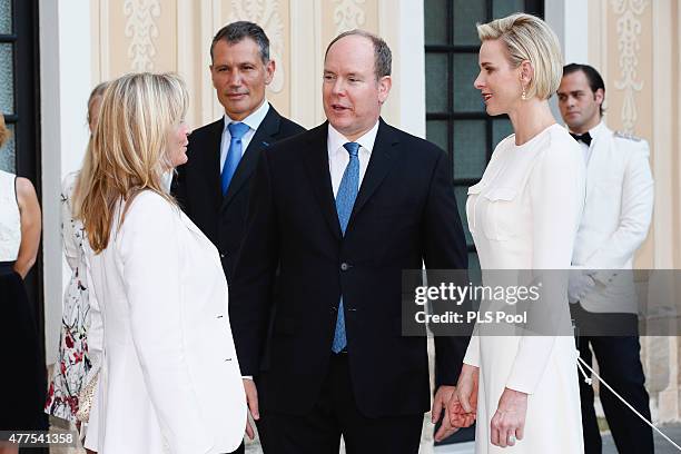 Prince Albert II of Monaco and Princess Charlene of Monaco greet actress Bo Derek during the Monaco Palace cocktail party of the 55th Monte Carlo TV...