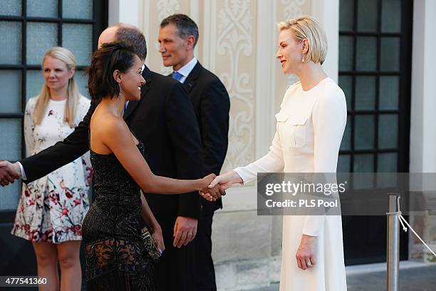 Prince Albert II of Monaco and Princess Charlene of Monaco greet actress Kat Graham during the Monaco Palace cocktail party of the 55th Monte Carlo...