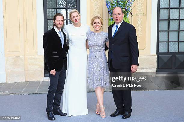 Prince Albert II of Monaco and Princess Charlene of Monaco pose with actors Aaron Stanford and Amanda Schull during the Monaco Palace cocktail party...