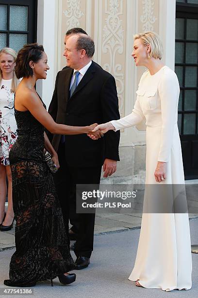 Prince Albert II of Monaco and Princess Charlene of Monaco greet actress Kat Graham during the Monaco Palace cocktail party of the 55th Monte Carlo...