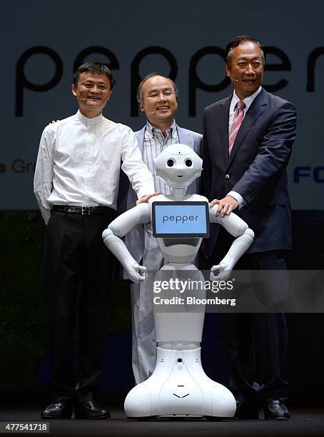 Billionaire Jack Ma, chairman of Alibaba Group Holding Ltd., left, billionaire Masayoshi Son, chairman and chief executive officer of SoftBank Corp.,...