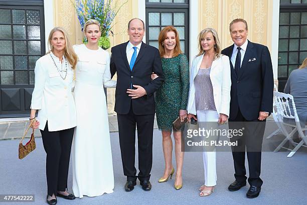 Prince Albert II of Monaco and Princess Charlene of Monaco pose with actors Lindsay Wagner, Stephanie Powers, Bo Derek and Lee Majors during the...