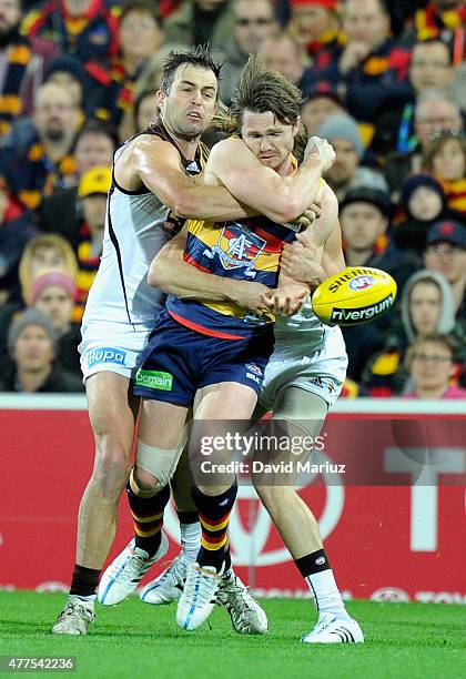 Brian Lake of the Hawks tackles Patrick Dangerfield of the Crows during the round 12 AFL match between the Adelaide Crows and the Hawthorn Hawks at...