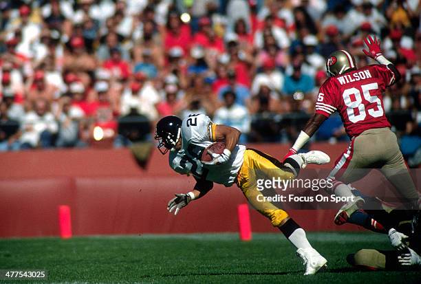 Rod Woodson of the Pittsburgh Steelers runs with the ball after an interception against the San Francisco 49ers during an NFL football game October...