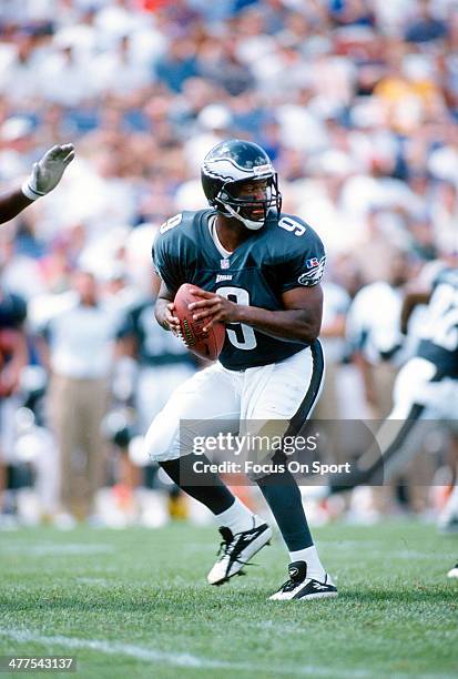Rodney Peete of the Philadelphia Eagles drops back to pass against the New England Patriots during an NFL Football game circa 1996 at Foxboro Stadium...