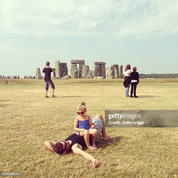 father and daughter relaxing near stonehenge - jodie griggs stock pictures, royalty-free photos & images