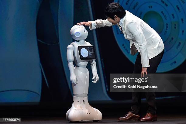 Comedian Koji Imada talks with Pepper during the news conference on June 18, 2015 in Chiba, Japan. Softbank Corp. Announced that its humanoid...