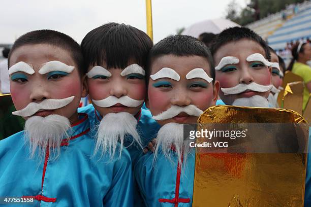 Performers pose during rehearsal of 15th China Ankang Hanjiang River Dragon Boat Festival on June 18, 2015 in Ankang, Shaanxi Province of China....