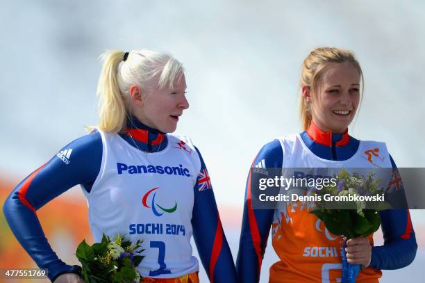 Gold medallists Kelly Gallagher of Great Britain and guide Charlotte Evans during the flower ceremony for the Women's Super-G - Visually Impaired...