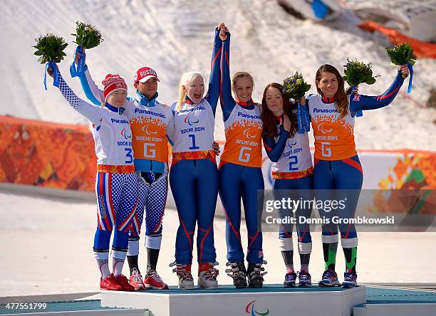 Silver medallists Aleksandra Frantceva of Russia and guide Aleksandra Frantceva, gold medallists Kelly Gallagher of Great Britain and guide Charlotte...