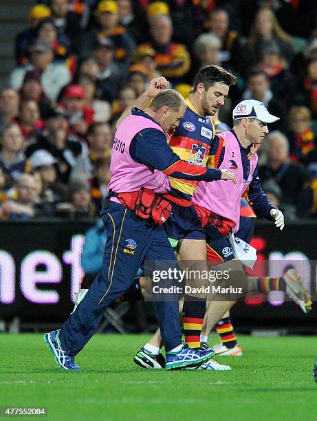 Taylor Walker of the Crows comes off with injury during the round 12 AFL match between the Adelaide Crows and the Hawthorn Hawks at Adelaide Oval on...