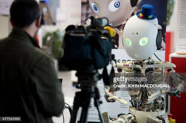 Cameraman shoots Roboy, a humanoid robot developed at the Artificial Intelligence Laboratory of the University of Zurich, at the 2014 CeBIT...