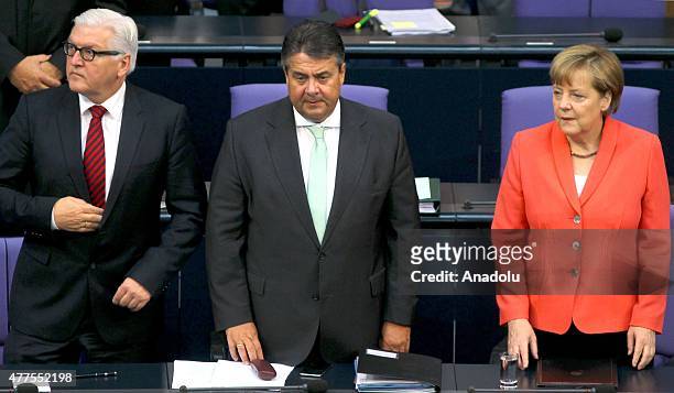 German Chancellor Angela Merkel stands next to German Vice Chancellor, Economy and Energy Minister Sigmar Gabriel and German Foreign Minister...