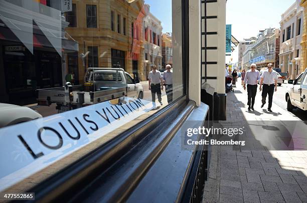 Pedestrians walk past an LVMH Moet Hennessy Louis Vuitton SA store on King Street in Perth, Australia, on Thursday, March 6, 2014. The Western...