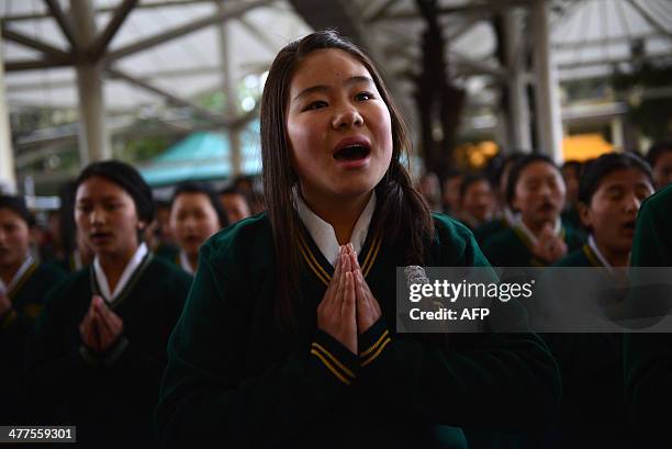 Young exiled Tibetan student prays with others during a ceremony in McLeodganj on March 10 held to mark the 55th anniversary of the Tibetan Uprising...