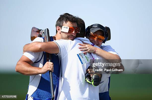 Manuel Mancini and Alessandra Perilli of San Marino celebrate with their coach after winning the bronze medal in the Mixed Team Trap bronze final...