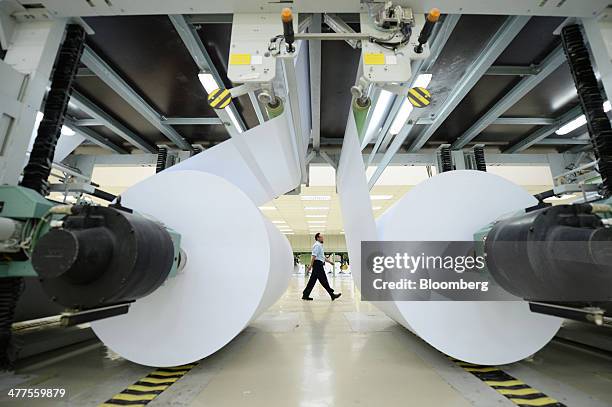 Finished paper is wound onto spools at Asia Pacific Resources International Holdings Ltd.'s pulp and paper manufacturing facility in Pelalawan, Riau...