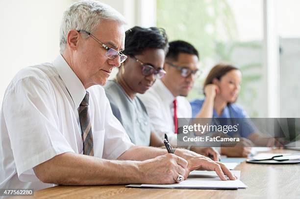 medical professional business meeting - agenda meeting stock pictures, royalty-free photos & images