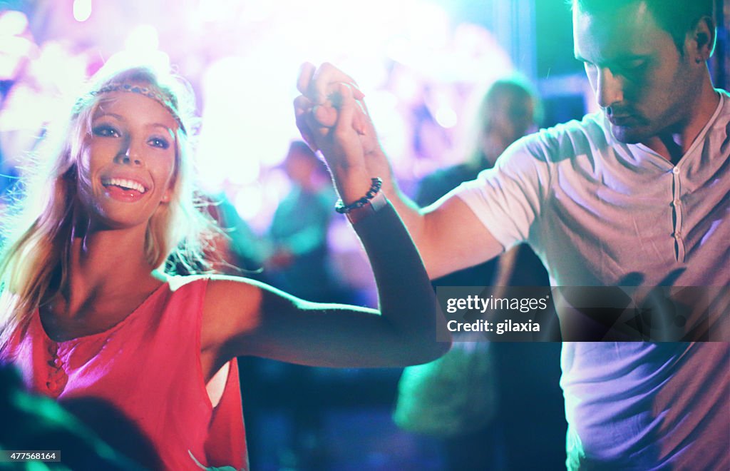 Two people dancing at concert.