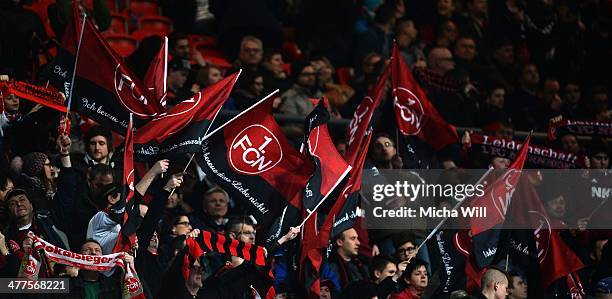 Fans wave flags shwoing the quote 'Ich bereue diese Liebe nicht' at the beginning of the Bundesliga match between 1. FC Nuernberg and Werder Bremen...