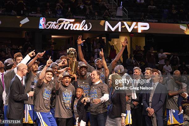 Finals: Golden State Warriors owner Joe Lacob victorious with players and holding up Larry O'Brien Trophy after winning Game 6 and championship...