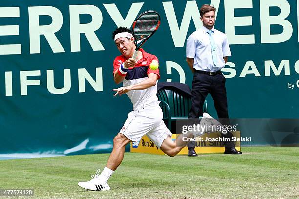 Kei Nishikori of Japan plays a forehand in his match against Dustin Brown of Germany during day four of the Gerry Weber Open at Gerry Weber Stadium...