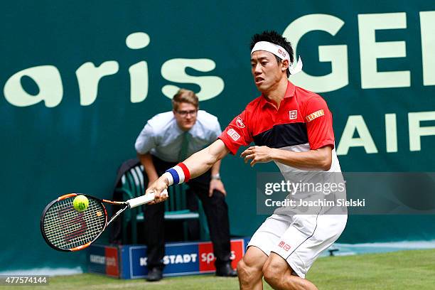 Kei Nishikori of Japan plays a forehand in his match against Dustin Brown of Germany during day four of the Gerry Weber Open at Gerry Weber Stadium...