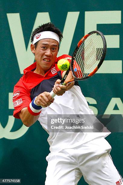 Kei Nishikori of Japan plays a forehand in his match against Dustin Brown of Germany during day four of the Gerry Weber Open at Gerry Weber Stadium...