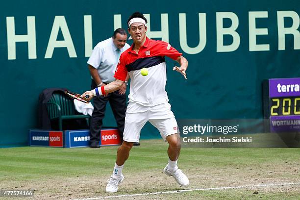 Kei Nishikori of Japan plays a forehand in his match against Dustin Brown of Germany during day four of the Gerry Weber Open at Gerry Weber Stadium...