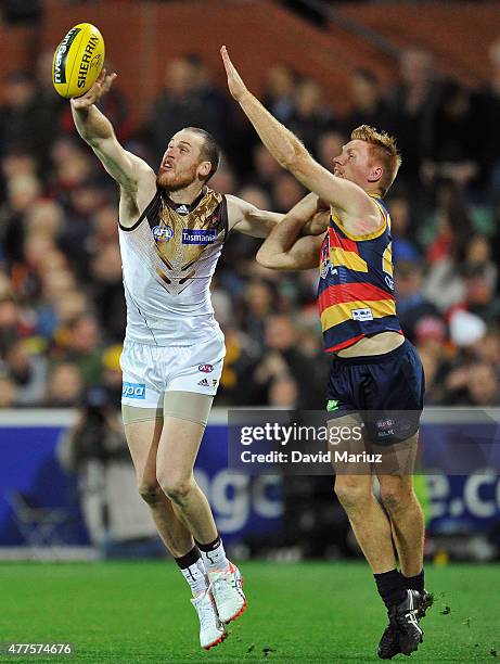 Kyle Cheney of the Crows and Jarryd Roughead of the Hawks contest the ball during the round 12 AFL match between the Adelaide Crows and the Hawthorn...