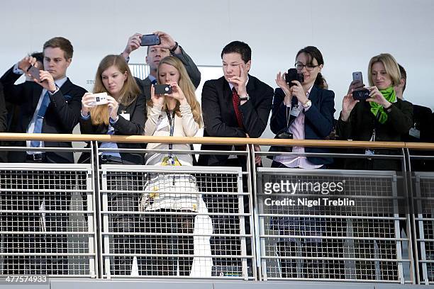 Employees of IBM take pictures of the visit of German Chancellor Angela Merkel at the IBM stand at the 2014 CeBIT technology Trade fair on March 10,...
