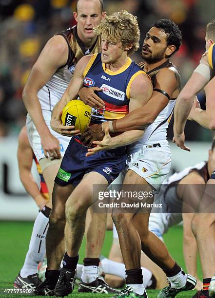 Rory Sloane of the Crows and Cyril Rioli of the Hawks contest the ball during the round 12 AFL match between the Adelaide Crows and the Hawthorn...