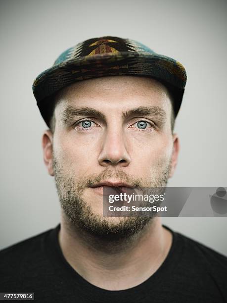 portrait of a young american man looking at camera - man cap stock pictures, royalty-free photos & images