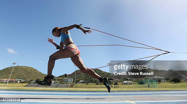 Phylicia George runs with bungies attached as part of her workout . The Canadian Sprint group attends a training camp at Kim Collins Athletics...