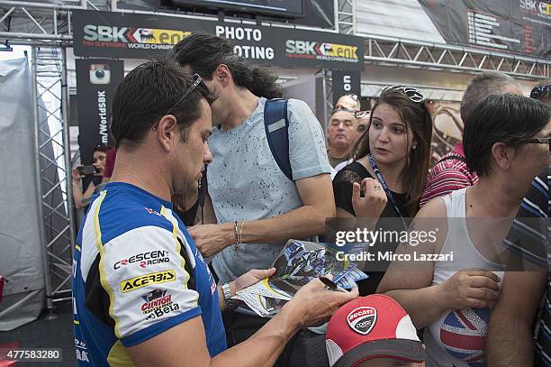 Randy De Puniet of France and Voltcom Crescent Suzuki signs autographs for fans during the paddock show during the FIM Superbike World Championship -...