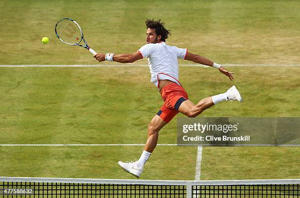 Feliciano Lopez of Spain volleys in his men's singles second round match against John Isner of USA during day four of the Aegon Championships at...