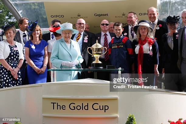 Queen Elizabeth II presents the Gold Cup to winner Graham Lee during day 3 of Royal Ascot 2015 at Ascot racecourse on June 18, 2015 in Ascot, England.