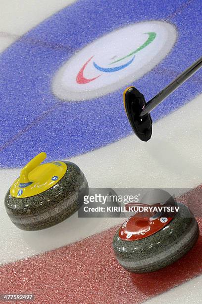 Athletes compete in Wheelchair Curling at XI Paralympic Olympic games in the Ice Cube Curling Centre stadium near Sochi on March 10, 2014. AFP...