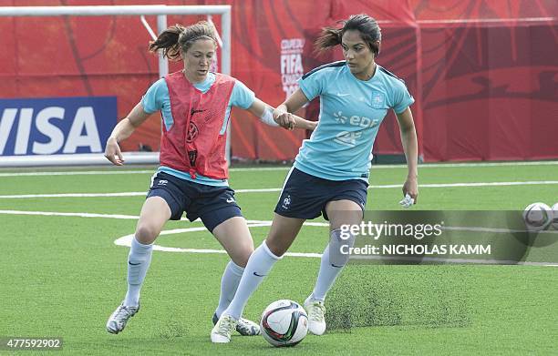 France's Louisa Necib and Elise Bussaglia take part in a training session in Ottawa on June 18, 2015 three days before France's Round of 16 2015 FIFA...