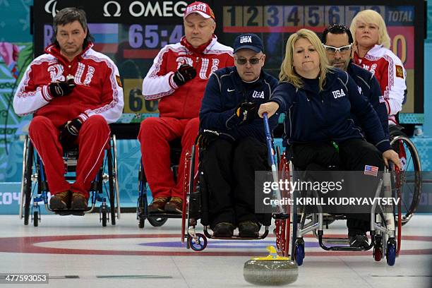 Penny Greely pushes the stone during the match between USA and Russia in Wheelchair Curling at XI Paralympic Olympic games in the Ice Cube Curling...