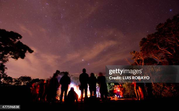 Yanacona indigenous ethnic group members perform the Yachak Yurak ritual around a fire in a rural area of Felidia, Valle del Cauca department,...