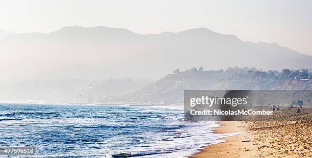 santa monica beach on misty evening mountains in background - santa monica beach stock pictures, royalty-free photos & images