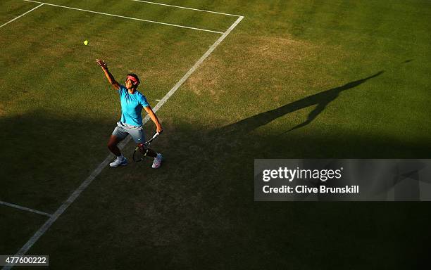 Rafael Nadal of Spain serves partnering Marc Lopez of Spain in their men's doubles quarter-final match against Daniel Nestor of Canada and Leander...