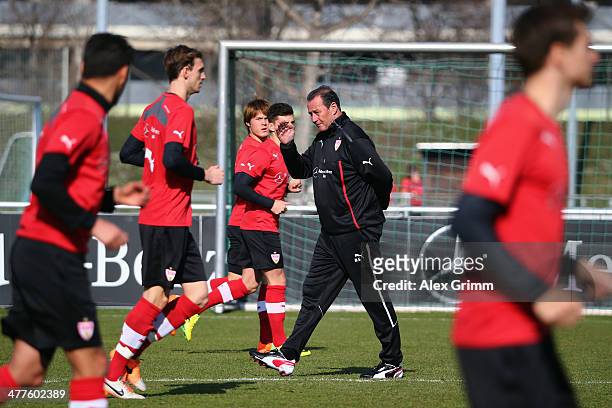 New head coach Huub Stevens of Stuttgart walks past the players during a training session at the club's training ground on March 10, 2014 in...
