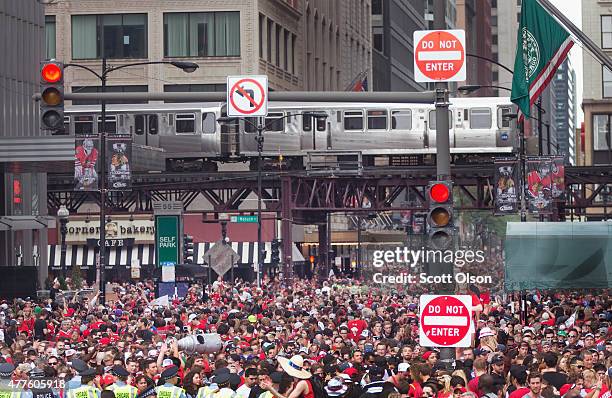 Fans gather downtown to watch a parade to celebrate the Chicago Blackhawks' winning of the Stanley Cup on June 18, 2015 in Chicago, Illinois. On...