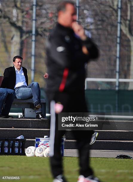 Manager Fredi Bobic of Stuttgart watches new head coach Huub Stevens during a training session at the club's training ground on March 10, 2014 in...