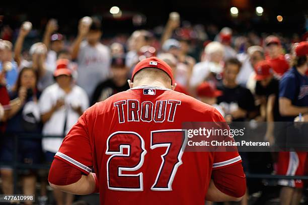 Mike Trout of the Los Angeles Angels signs autographs for fans before the MLB game against the Arizona Diamondbacks at Chase Field on June 18, 2015...