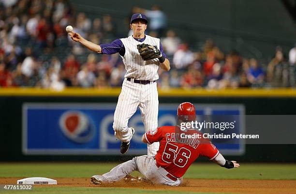 Infielder Nick Ahmed of the Arizona Diamondbacks throws over the sliding Kole Calhoun of the Los Angeles Angels to complete a double play during the...